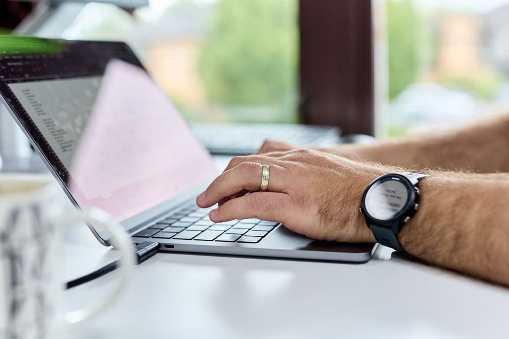 What is Phishing? How to Protect Your Business what is phishing? a close up of a laptop with a team member typing on the keyboard