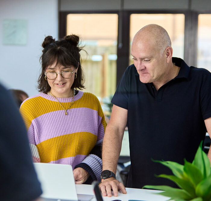 a man and woman looking at a laptop. it support for charities & non-profits based in hampshire.