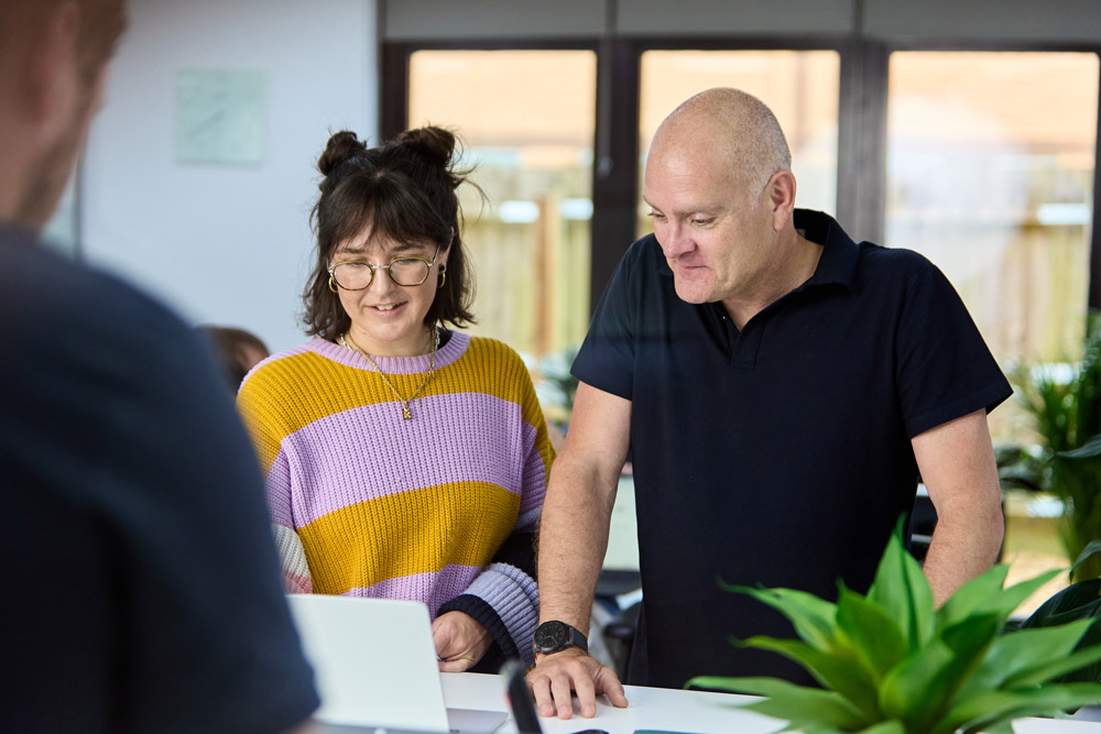 a man and woman looking at a laptop. it support for charities & non-profits based in hampshire.