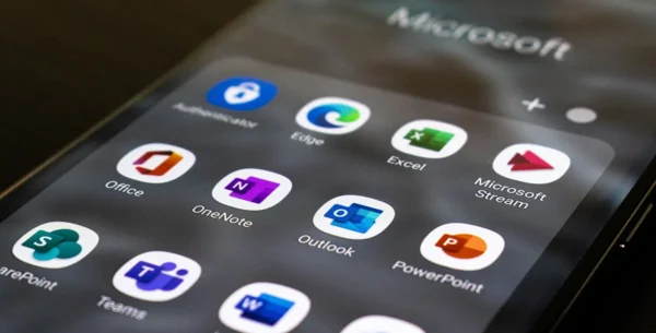 Microsoft nonprofit licenses to end. a phone screen with microsoft 365 apps on display