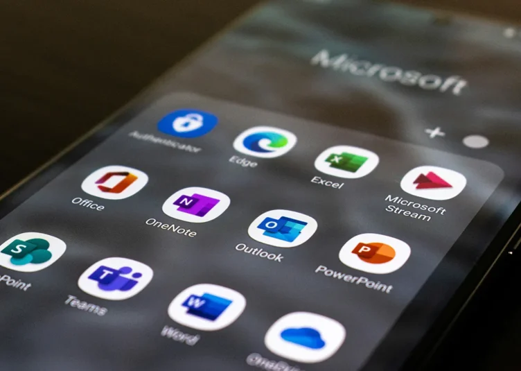 Microsoft nonprofit licenses to end. a phone screen with microsoft 365 apps on display