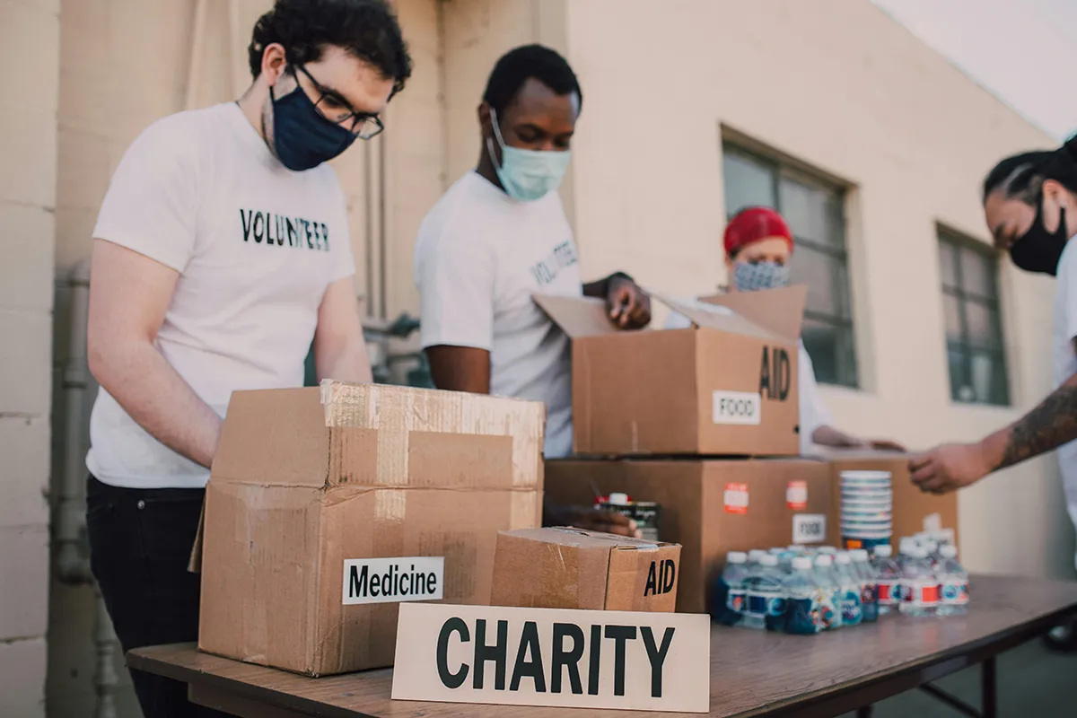 Free Microsoft Nonprofit Licenses to End in 2025 Microsoft charity licence ending. charity workers with donation boxes