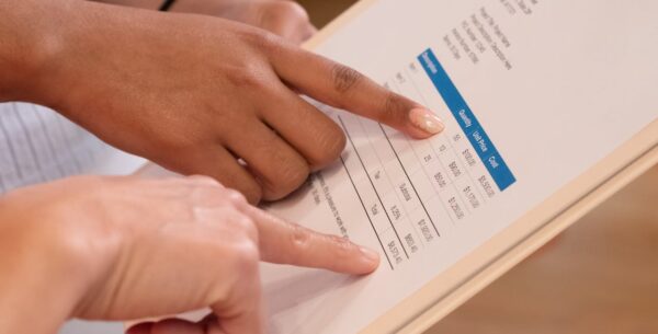 5 Signs You Need A New IT Provider 2 hands pointing at a recent invoice, showing the cost variation of some it providers