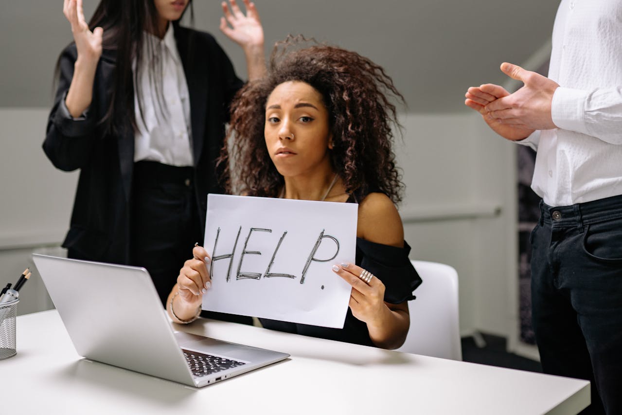 a woman holding up a paper sign 'help' feeling helpless and lost due to not having a clear IT strategy