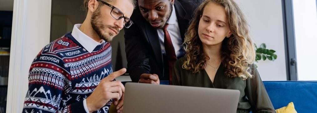 What You Need to Include in an AI Policy a group of people surrounding a laptop discussing