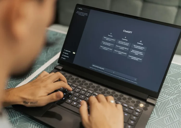 ai for business. a person on a laptop with chatgpt on the screen
