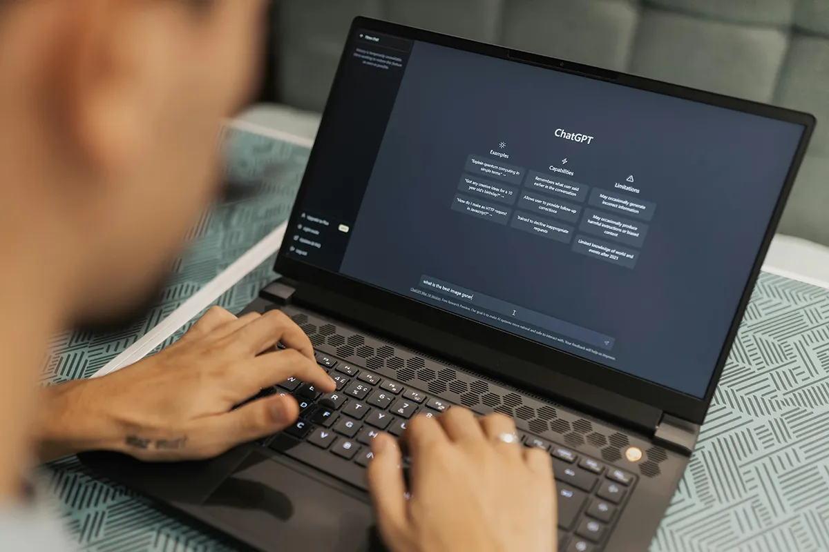 ai for business. a person on a laptop with chatgpt on the screen