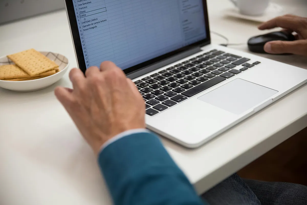 a worker on a laptop using excel. benefits of ai